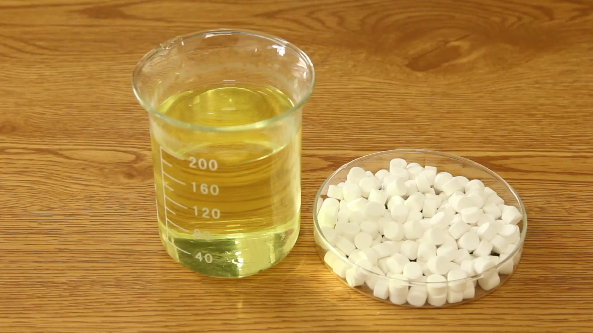 chlorine dioxide tablets and glass of water on table surface