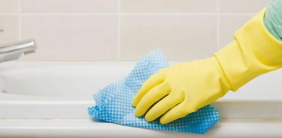 close shot of a hand cleaning surface with ClO2