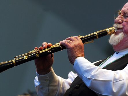 a man playing saxophone clarinet mouthpiece.