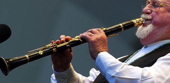 a man playing saxophone clarinet mouthpiece.